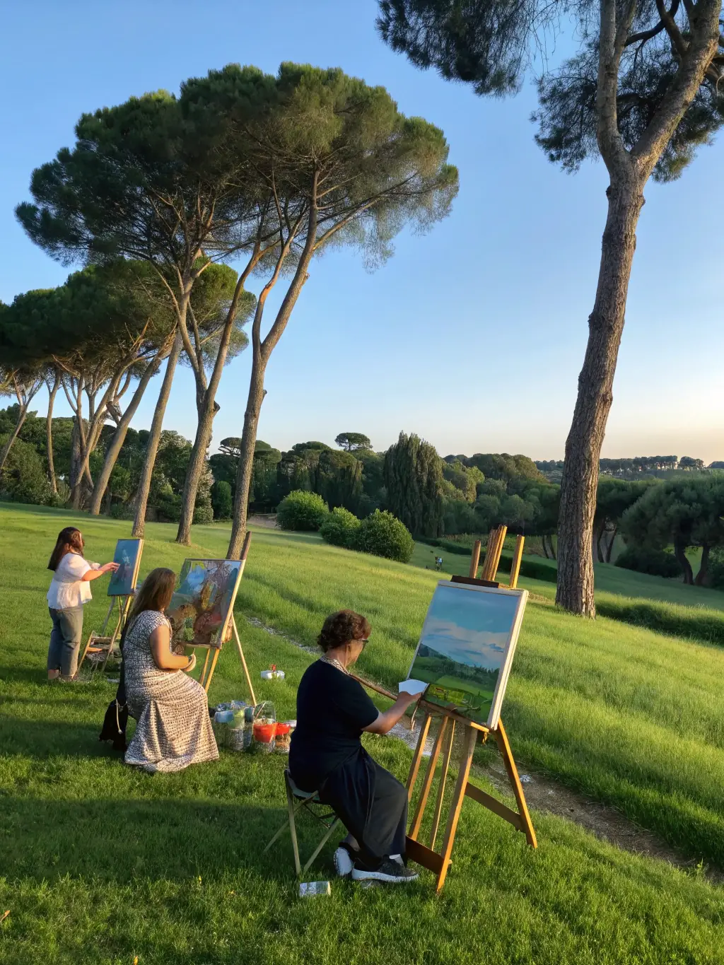 A photograph of a group of people participating in an outdoor painting session in a scenic location in Vaucluse, capturing the beauty of the landscape on canvas.